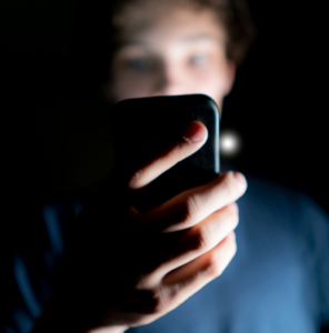 young-an-use-mobile-phone-late-at-night-in-a-dark-roomb-1156724613_cropped-296x300